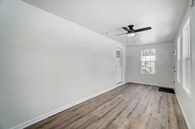 empty room with ceiling fan and light wood-type flooring