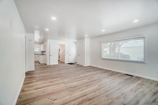 unfurnished living room with light hardwood / wood-style flooring