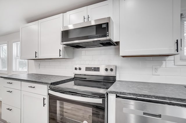 kitchen featuring white cabinetry, stainless steel appliances, and decorative backsplash