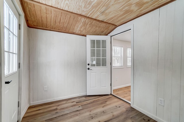 doorway with light hardwood / wood-style floors and wooden ceiling