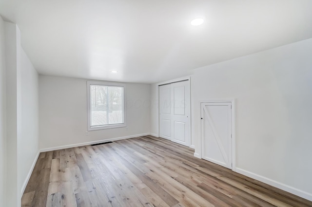 spare room featuring light hardwood / wood-style flooring