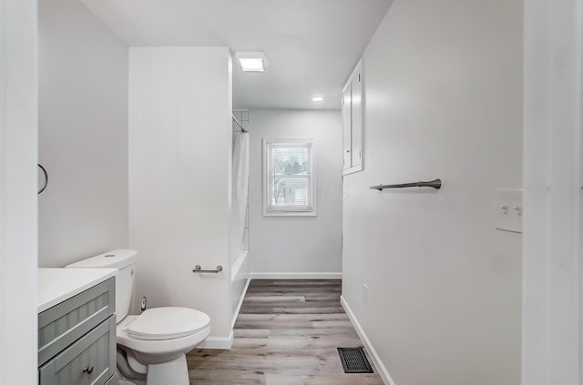 full bathroom with vanity, hardwood / wood-style floors, toilet, and shower / tub combo with curtain