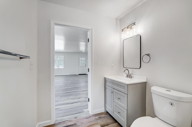 bathroom with vanity, hardwood / wood-style floors, and toilet