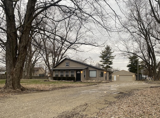 view of front of house featuring a garage and an outdoor structure