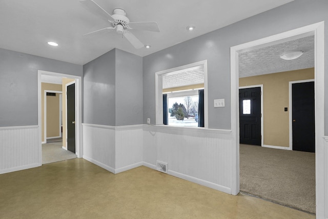 carpeted empty room with ceiling fan