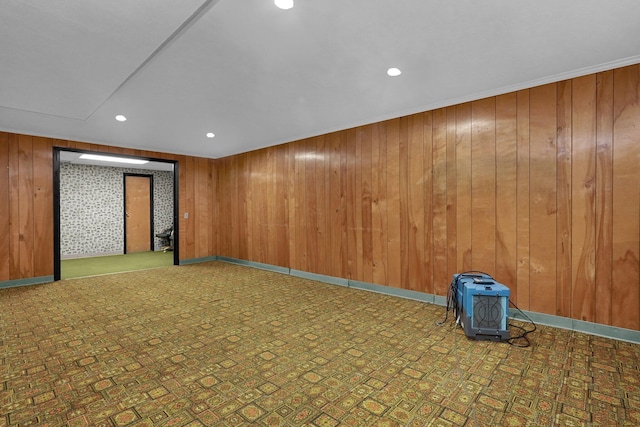 unfurnished room featuring wood walls