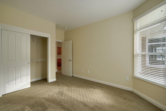 unfurnished bedroom with a closet and carpet flooring