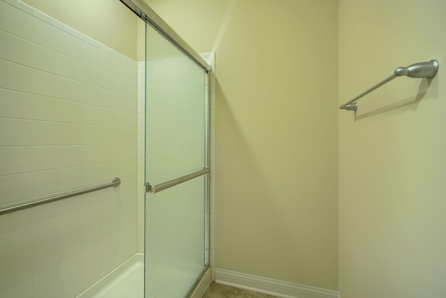 bathroom featuring a shower with door