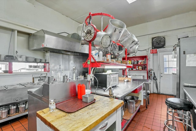 kitchen featuring tile patterned floors and wooden counters