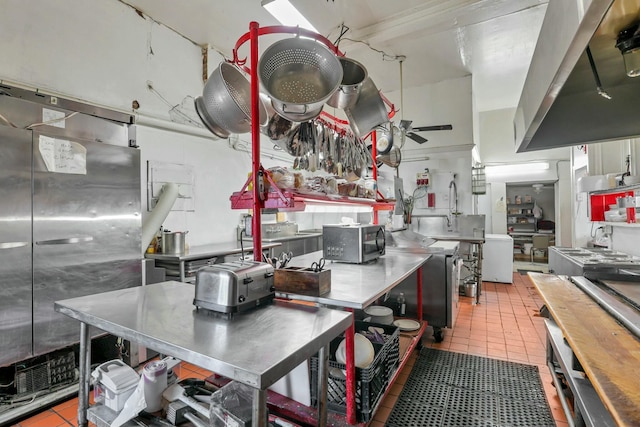 kitchen with stainless steel counters, tile patterned flooring, island exhaust hood, and ceiling fan