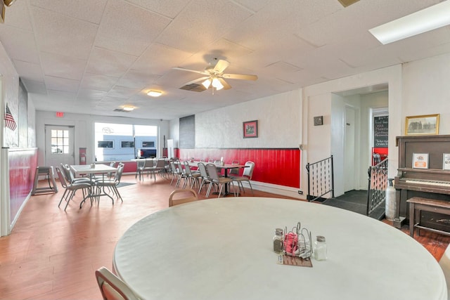 dining space featuring ceiling fan and wood-type flooring