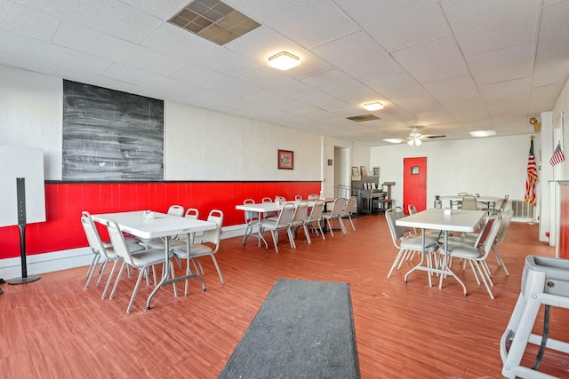 dining area with ceiling fan and wood-type flooring