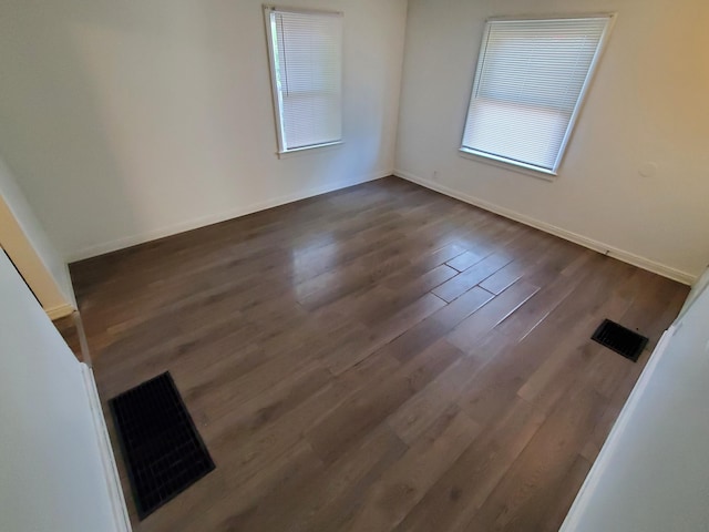 unfurnished room featuring dark hardwood / wood-style flooring