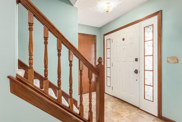 foyer featuring a textured ceiling