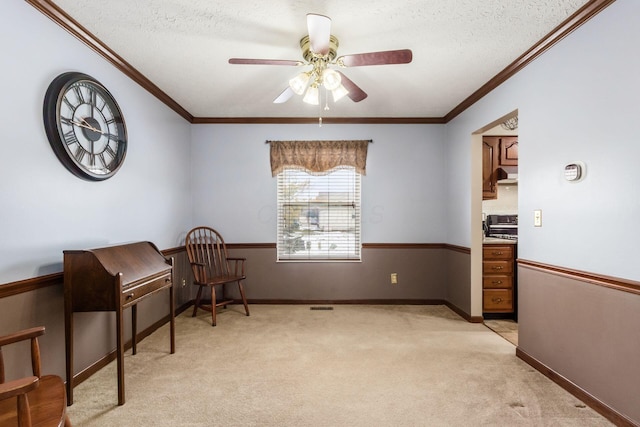 sitting room with ornamental molding, light colored carpet, and a textured ceiling