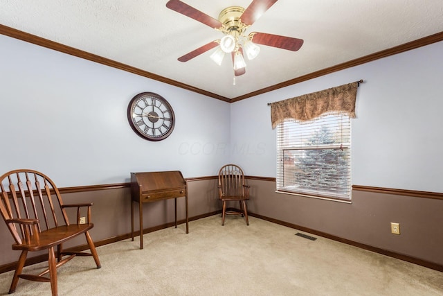 living area featuring ceiling fan, ornamental molding, and light carpet