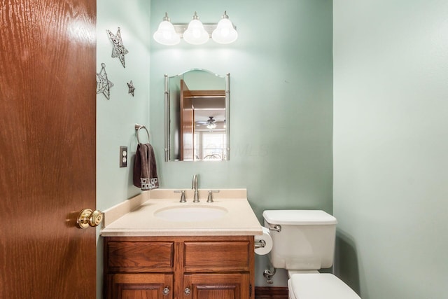 bathroom featuring toilet and vanity