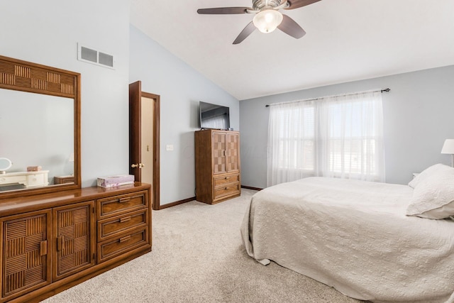 bedroom with light carpet, vaulted ceiling, and ceiling fan