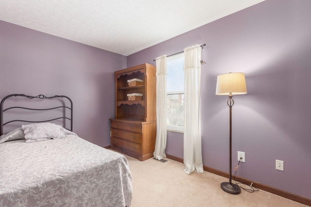 carpeted bedroom featuring a textured ceiling