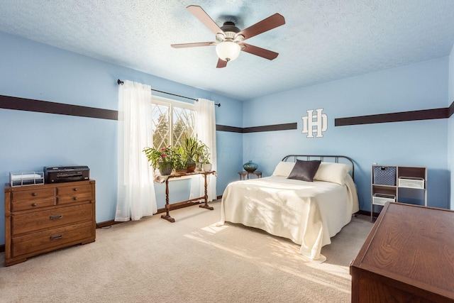 carpeted bedroom with a textured ceiling and ceiling fan