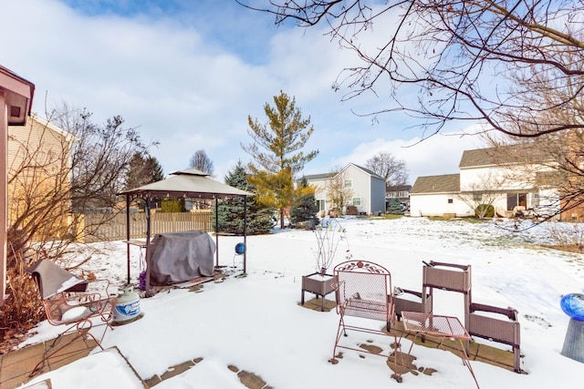 yard layered in snow featuring a gazebo