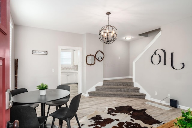 dining area featuring a chandelier and light wood-type flooring