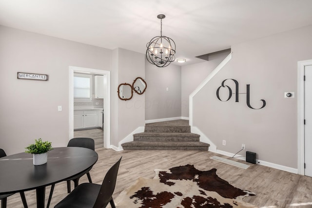 foyer entrance featuring a chandelier and light wood-type flooring