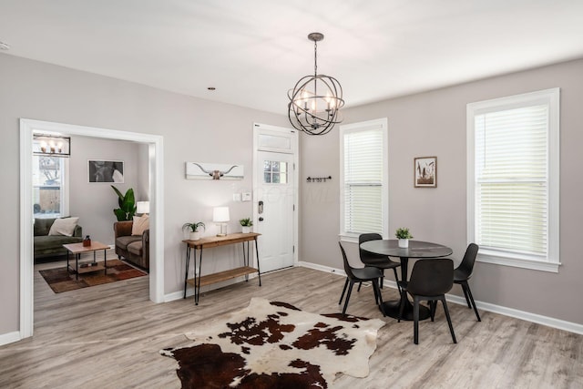 dining room featuring a notable chandelier and light hardwood / wood-style floors