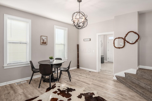 dining room with a notable chandelier and light hardwood / wood-style flooring