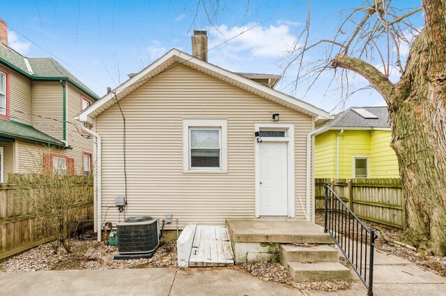 1017 Michigan Ave, Columbus, OH 43201 - back of property featuring a chimney, fence, and central AC
