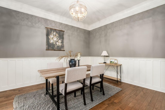 dining space with dark hardwood / wood-style floors and a chandelier