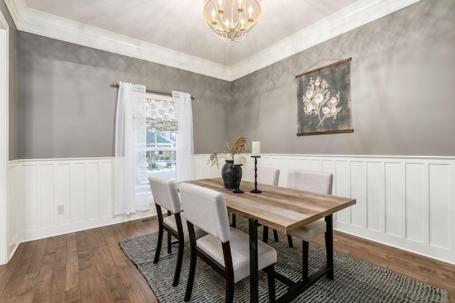 dining room with wood-type flooring and an inviting chandelier