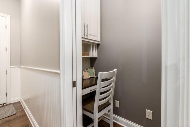 home office with dark hardwood / wood-style flooring