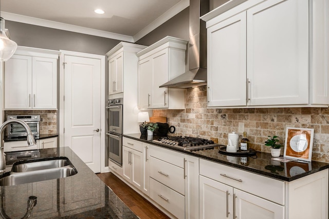 kitchen featuring white cabinetry, wall chimney exhaust hood, stainless steel appliances, and backsplash