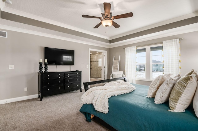 bedroom featuring carpet, a raised ceiling, ceiling fan, and ensuite bathroom