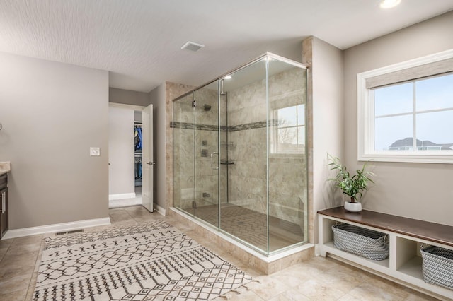 bathroom featuring vanity and an enclosed shower