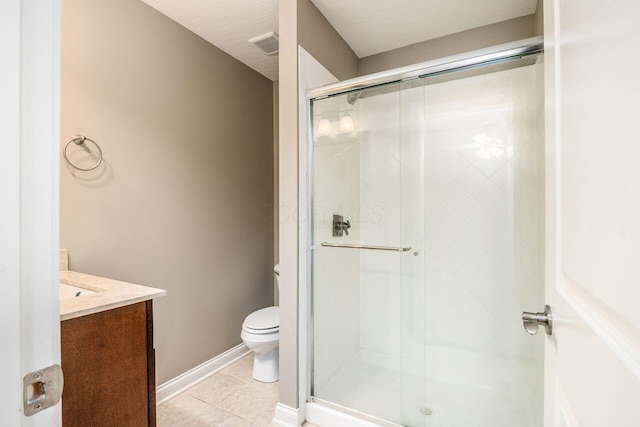 bathroom featuring vanity, tile patterned flooring, a shower with shower door, and toilet