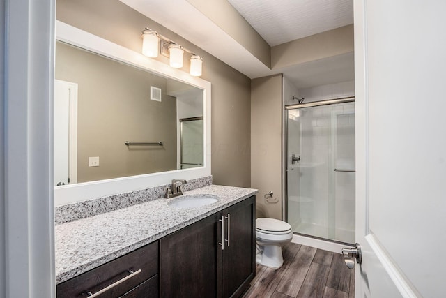 bathroom with vanity, toilet, and an enclosed shower