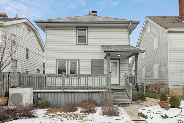 snow covered house featuring ac unit