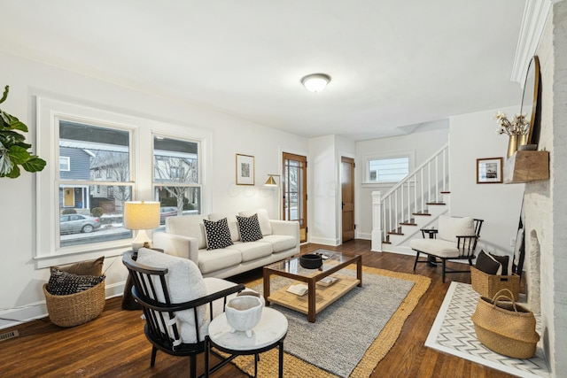 living room featuring dark wood-type flooring and a fireplace