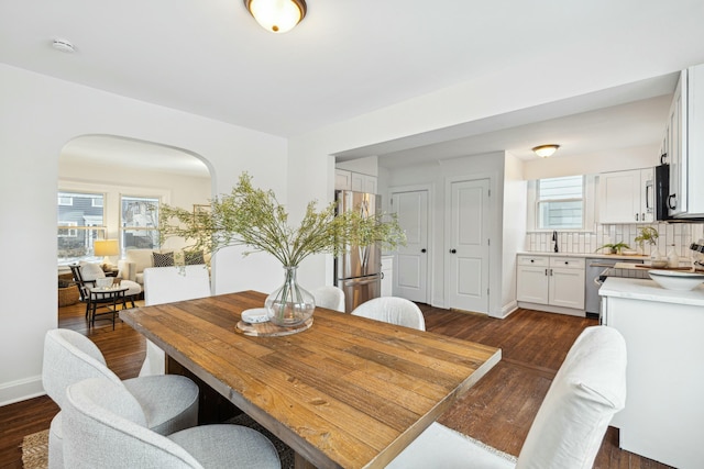 dining area featuring dark wood-type flooring