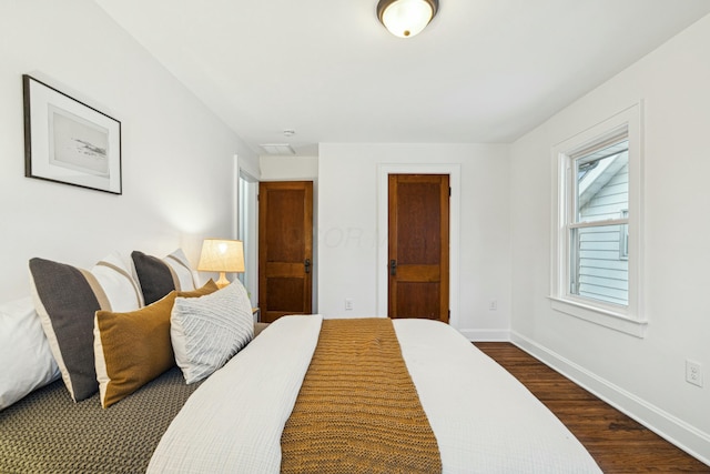 bedroom with dark hardwood / wood-style floors