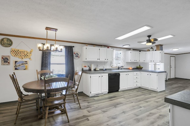 kitchen featuring white cabinetry, dishwasher, light wood-type flooring, hanging light fixtures, and a textured ceiling