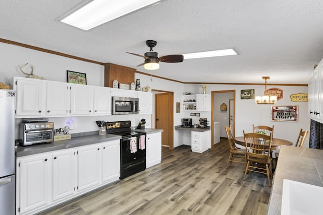 kitchen with white cabinetry, hanging light fixtures, crown molding, and appliances with stainless steel finishes