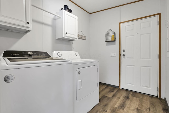 laundry area featuring cabinets, ornamental molding, dark hardwood / wood-style floors, and washing machine and dryer