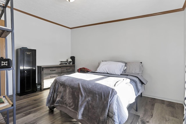 bedroom featuring dark wood-type flooring and ornamental molding