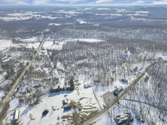 snowy aerial view featuring a mountain view