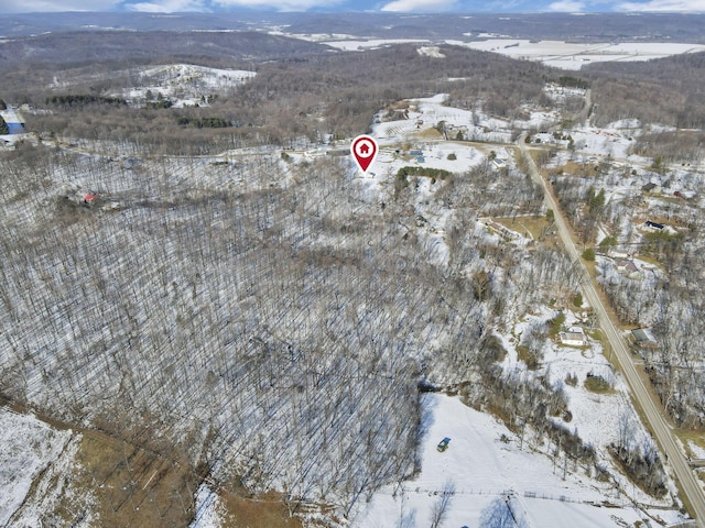 snowy aerial view with a mountain view