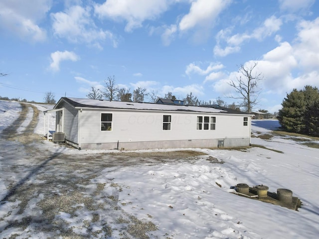 snow covered property featuring cooling unit