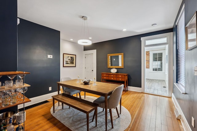 dining area featuring light wood-type flooring